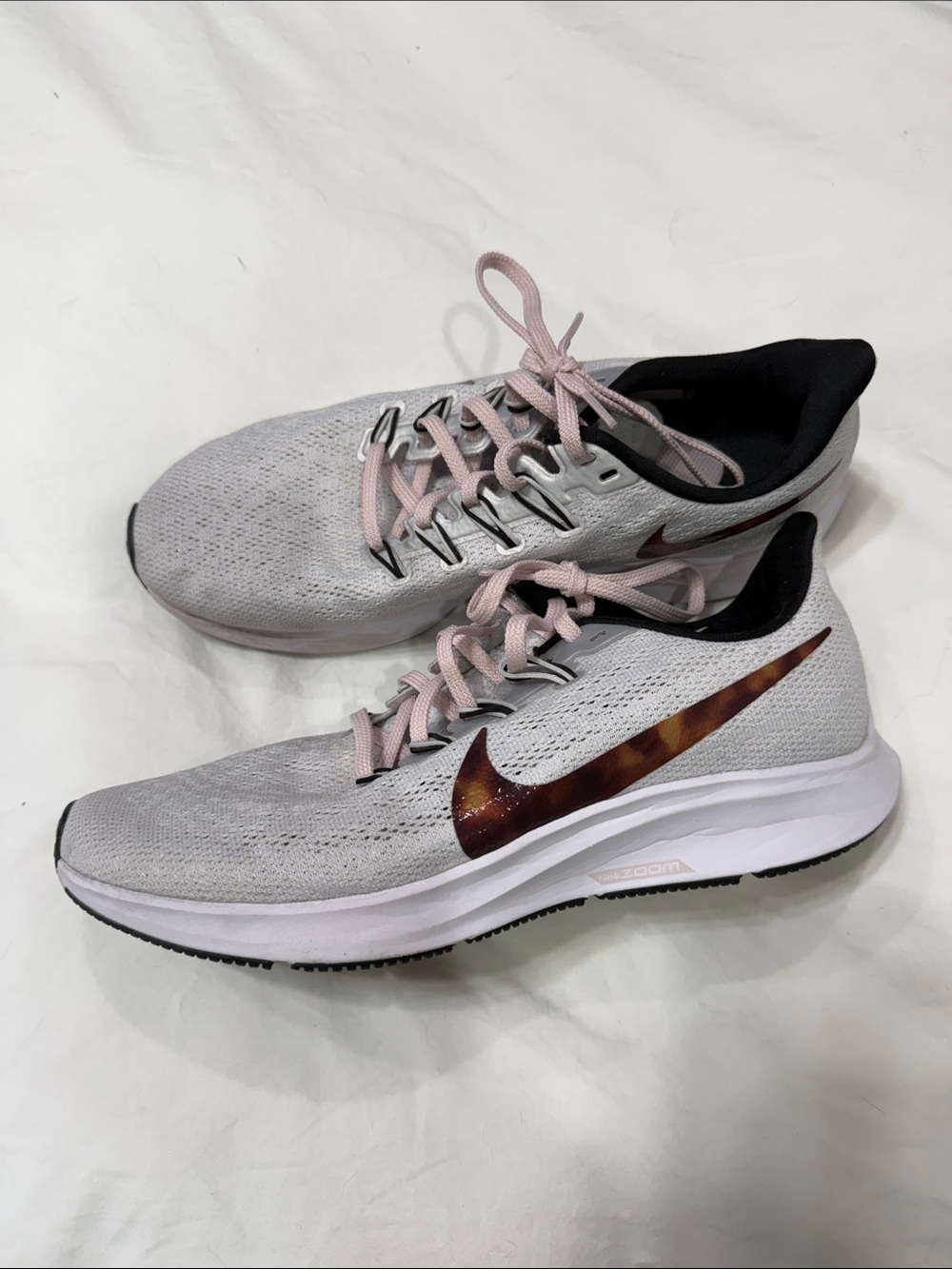 Nike Women's White Running Sneakers with Pink Laces and Brown Swoosh